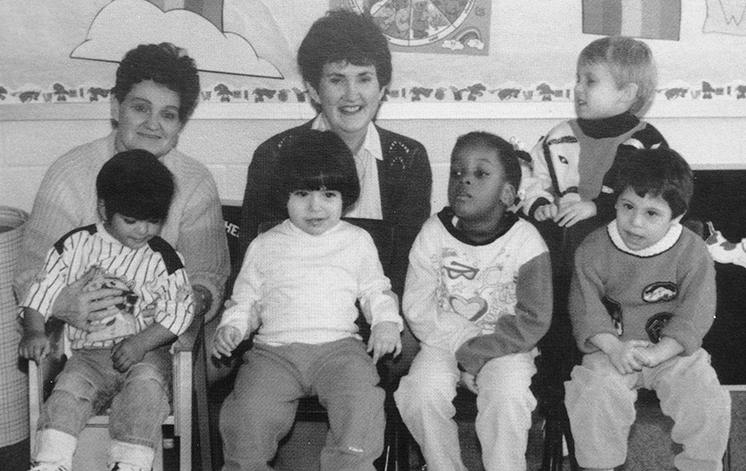 Black and white photograph from Forestdale’s 1990 to 1991 yearbook showing the pre-school class. Five students and two teachers are pictured. 